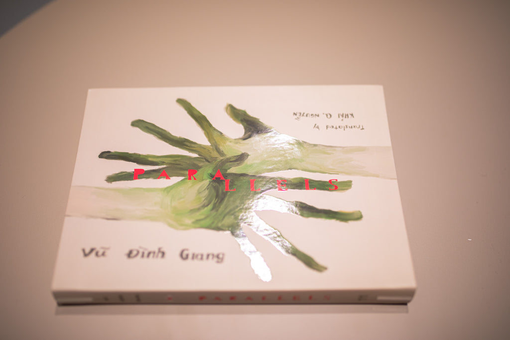 Book cover with green hand design and  a beige background, detail on UV spot finishing