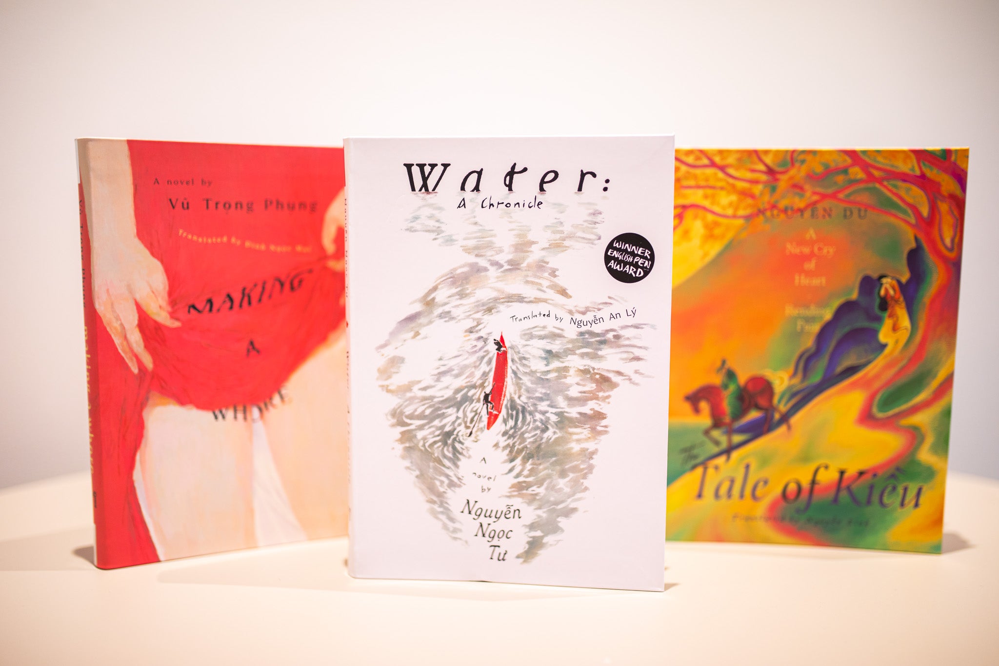 Three books with colorful covers on a white background