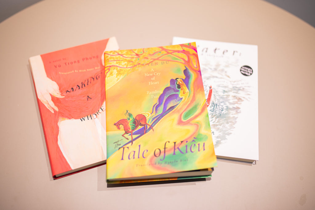 Three books on a beige surface, with 'Tale of Kieu' being colorful and prominent.
